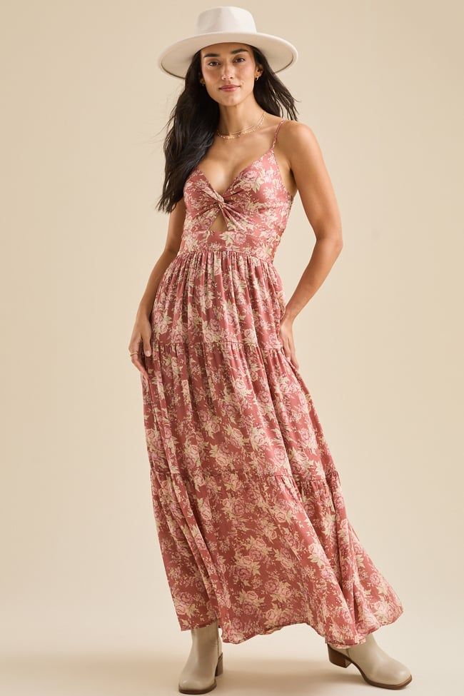 This floral maxi dress features a charming knot detail in the front and adjustable straps for a customizable fit. The flowing silhouette and delicate floral print create a feminine and effortlessly elegant look, perfect for special occasions or everyday wear. Brunch Maxi Dress With Knotted Straps, Elegant Ditsy Floral Print Maxi Dress For Vacation, Elegant Beach Maxi Dress With Ditsy Floral Print, Maxi Dress With Knotted Spaghetti Straps For Garden Party, Garden Party Maxi Dress With Knotted Spaghetti Straps, Garden Party Maxi Dress With Spaghetti And Knotted Straps, Brunch Sundress With Knotted Straps, Flowy Maxi Dress With Knotted Straps, Flowy Floral Print Maxi Dress With Spaghetti Straps