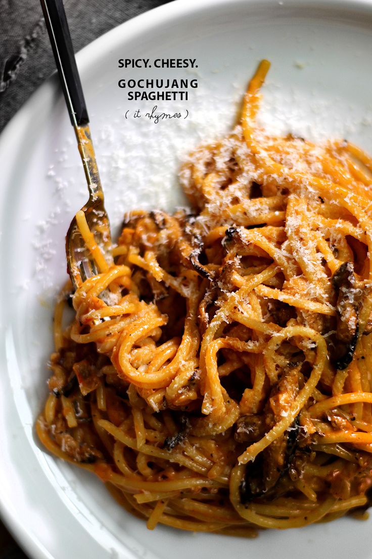 a white plate topped with pasta covered in sauce