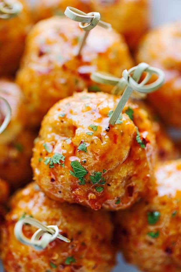 some meatballs are piled on top of each other and garnished with parsley