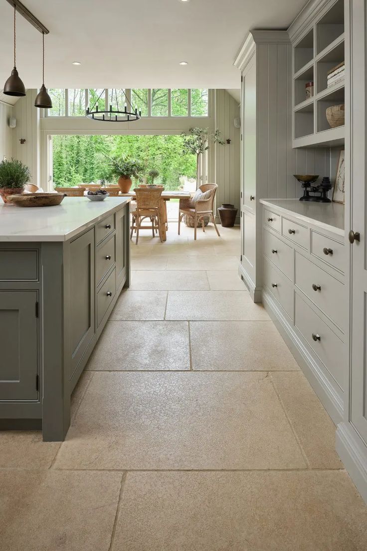 a large kitchen with an island in the middle and lots of cabinets on both sides