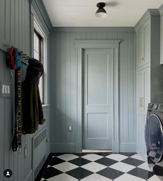 a room with a checkered floor and a door that has a light on it