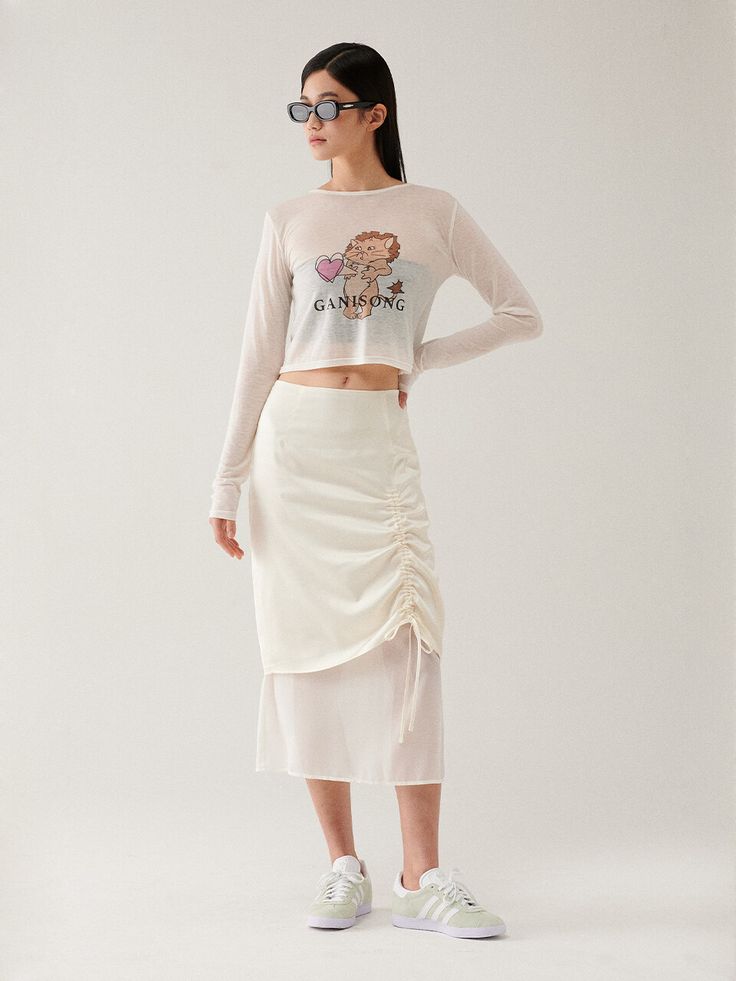 Editor's Notes This skirt is made of polyester and rayon. This skirt has an elegant design such as shirring detail, you can adjust the shirring by using the string. Wear this item with a solid blouse and mules for a feminine mood. - Classic design midi-length skirt- Layered detail with contrast fabric- H-line and a shiny fabric detail- Must-have item and a stylish item Measurements(in.)Size (S/M) - Total Length: 30.51 in. / 31.10 in. - Waist: 13.38 in. / 14.17 in. - Hip: 18.11 in. / 18.90 in. - Hem: 19.68 in. / 20.47 in. *Model info: Yealin Lee / Height 5' 70, Bust 30 in., Waist 22 in., Hip 33 in., Wearing S or One size Composition & Care- Shell 1: 58% Polyester 42% Rayon- Shell 2: 100% Polyester- Dry cleaning recommended- Do not b White Long Ruched Skirt, White Ruched Long Skirt, White Ruched Asymmetrical Skirt, White Asymmetrical Ruched Skirt, White Tiered Skirt With Drawstring, Spring Asymmetrical Skirt With Ruched Sides, Long Skirt With Ruched Sides For Spring, Ruched Draped Skirt For Spring, Relaxed Ruched Draped Skirt For Spring