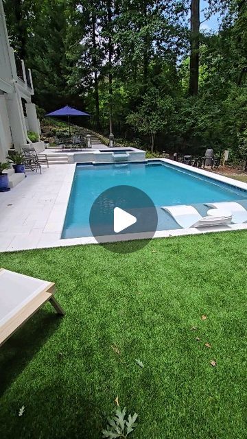 a backyard with a pool and lawn furniture