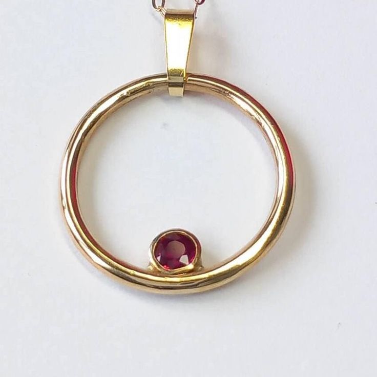 Feel fabulous and loved in this solid 9ct yellow gold and ruby circular pendant.  Named the 'Oriana Rose', meaning Golden Sunrise, this pendant shimmers and shines around your neck, evoking a real festive feel. Symbolising the circle of life in a year, the Oriana Rose is an ideal Mother's Day gift. The ruby is a rich and vibrant red; red being the colour of  love and glints beautifully in its rub over setting. You don't need to worry about buying the correct size; this pendant fits all and has a clip on bail so you can wear it with or without the bail and includes the chain photographed. So why do you need this pendant?  A ring might not be the exact message you want to convey and bracelets are tricky to size as well. This pendant is on trend, but is unique in its design. My silver and gol Life In A Year, Rose Meaning, Gold Ruby Necklace, Golden Sunrise, July Birthday, Ruby Pendant, Ruby Necklace, Shimmer N Shine, Red Stone