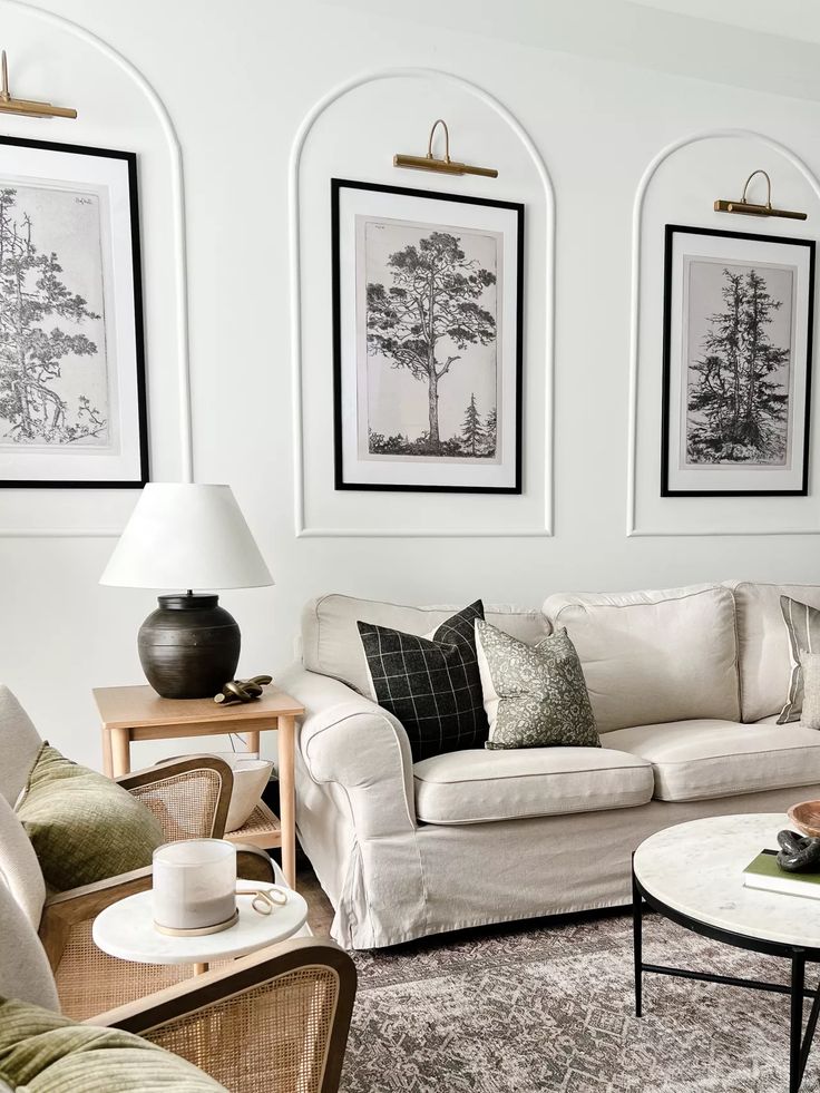 a living room filled with furniture and pictures on the wall above it's coffee table