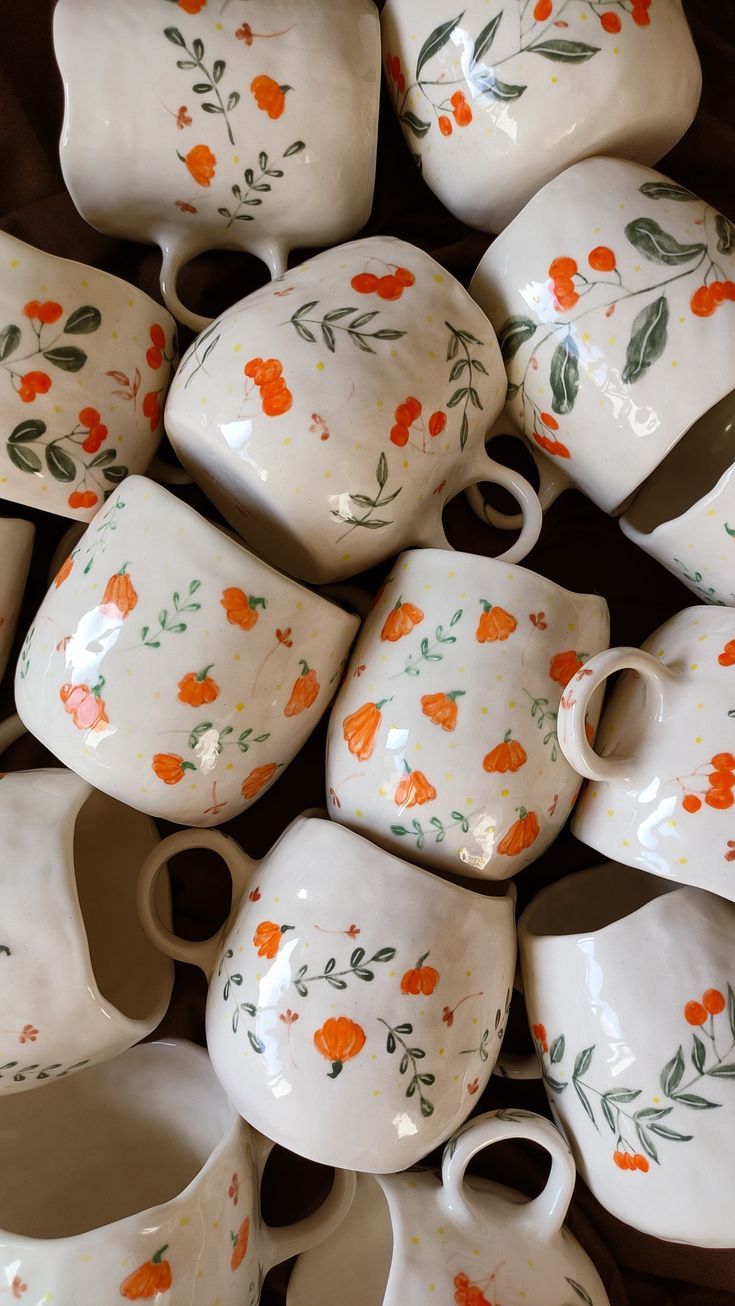 a pile of orange and white dishes sitting next to each other