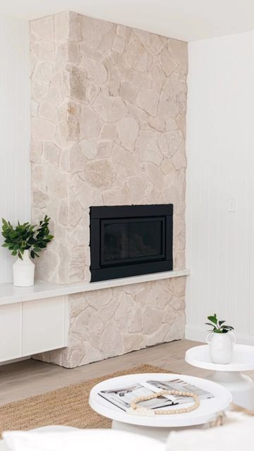 a living room filled with furniture and a fire place next to a wall mounted tv