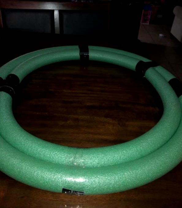 a green hose sitting on top of a wooden table