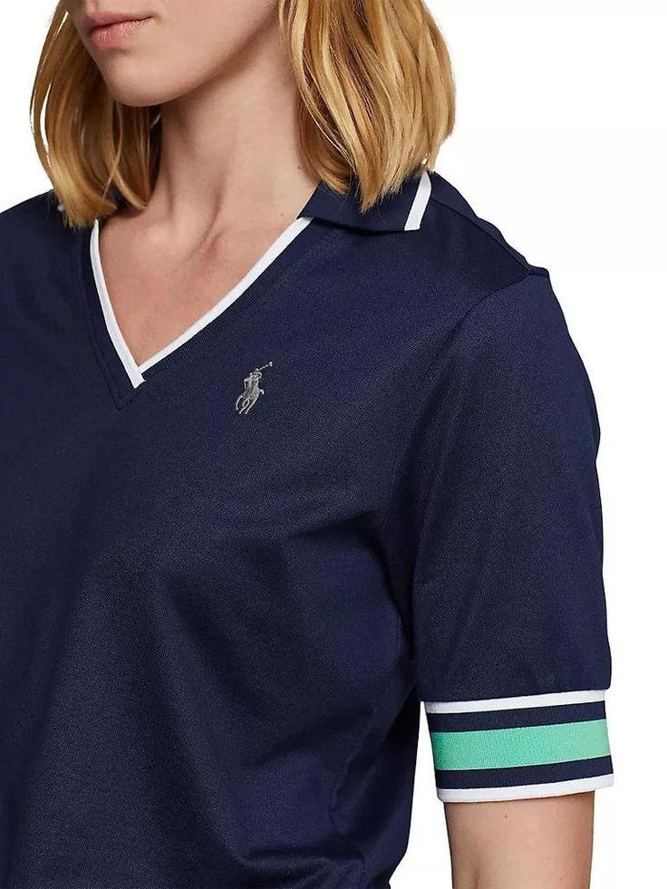 The RLX Ralph Lauren Tailored Fit Cricket Polo Shirt stands out with cricket-inspired stripes adorning its neckline and cuffs. Made from a cotton-blend jersey, this polo shirt offers softness and features the 'RXL' logo on the right shoulder, while its tailored fit showcases a slim silhouette with a gentle taper..Spread collar.Short sleeves.Pulls over.54% polyester/46% cotton.Imported.SIZE & FIT.Shoulder to hem: about 25'.Model measurements: 5'10' tall.Model is wearing a US size Small.The RLX Ralph Lauren Tailored Fit Cricket Polo Shirt stands out with cricket-inspired stripes adorning its neckline and cuffs. Made from a cotton-blend jersey, this polo shirt offers softness and features the 'RXL' logo on the right shoulder, while its tailored fit showcases a slim silhouette with a gentle ta Sporty Golf Tops With Three Stripes, Sporty Collared Top With Signature Stripes, Cotton Golf Tops With Contrast Stripes, Preppy Polo Collar Golf Top, Preppy Polo Collar Top For Golf, Preppy Cotton Tops For Golf, Ralph Lauren Women, Ralph Lauren Outfits, Polo Shirt Women