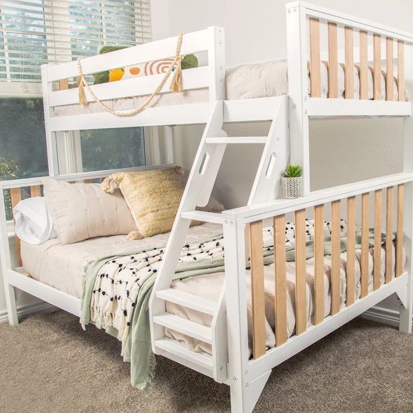 a white bunk bed sitting in a bedroom next to a window with blinds on the windowsill