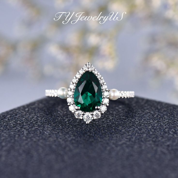 White Gold Engagement Ring Pear Shaped Lab Emerald Bridal Ring Akoya Pearl Wedding Ring Halo Diamond May Birthstone Tear Antique Jewelry Items Description: Items as shown in: Solid 14K White Gold Also available in 14K/18K White/Rose/Yellow Gold, & Platinum (Please select the metal and gemstone on the drop down menu) Engagement Ring: * Center stone: Lab Emerald, Pear shaped, Size: 6*9mm, approx 1.70ct * Side Stone: Akoya Pearl, size 2.5mm * Accents: Natural Diamonds, VS clarity, G color, 0.33 Pear Shaped Fine Jewelry For Weddings, Wedding Ring With Emerald Center Stone, Pear-shaped Center Stone Promise Ring, Wedding Halo Ring With May Birthstone In Round Cut, Emerald Halo Ring For Wedding, Wedding Emerald Ring May Birthstone, Wedding Halo Setting Ring With May Birthstone, May Birthstone Halo Design Wedding Jewelry, May Birthstone Halo Ring For Wedding