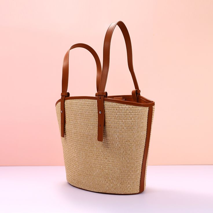 Add a summer-inspired touch to your accessories edit with this straw bucket tote bag. Woven from straw with leather trimmings, this handbag makes us look forward to summer and escapism. It comes with an open top and is roomy enough for all your essentials. Easy-to-wear wardrobe staples that combine classic and contemporary styles.Width (cm): 28 cmHeight (cm): 16 Color: Light brownInterior Material: Polyester CottonMaterial_bag: StrawBagType: Handbag & Shoulder bagBag Length: 28 cm Spring Shopping Jute Shoulder Bag, Spring Large Capacity Jute Bucket Bag, Straw Beach Bag For Shopping, Large Capacity Jute Bucket Bag For Spring, Chic Beach Bag With Bamboo Handle For Travel, Elegant Bucket Bag With Braided Handles For Beach, Chic Beach Bags With Bamboo Handle, Chic Beach Bag With Bamboo Handle, Large Capacity Straw Shoulder Bag For Shopping