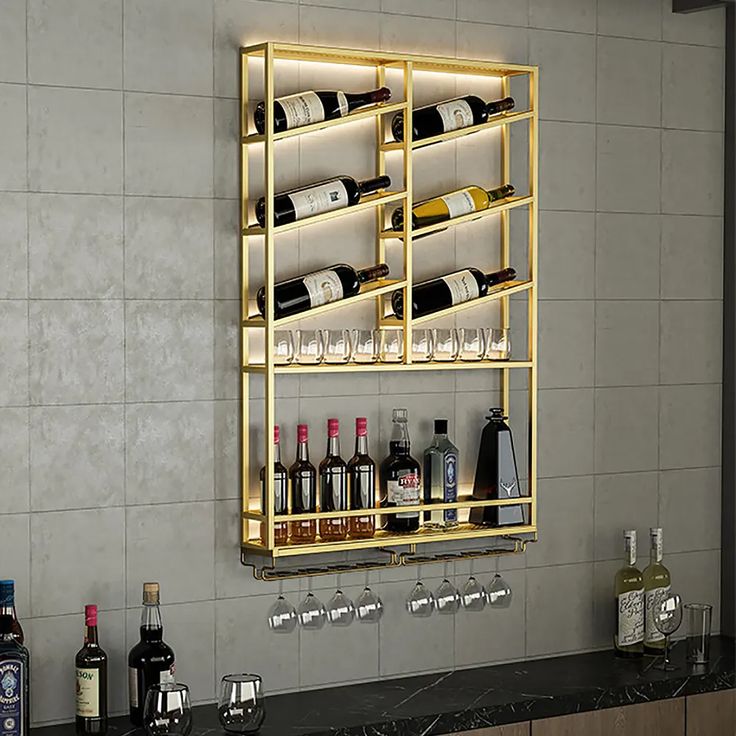 a wall mounted wine rack filled with lots of bottles and glasses on top of a counter