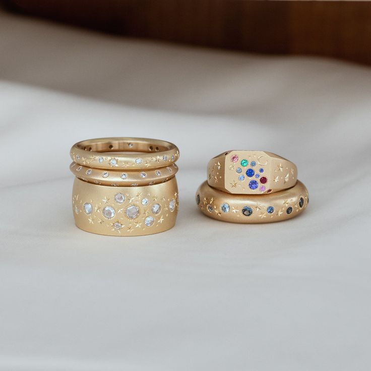 three gold colored rings sitting next to each other