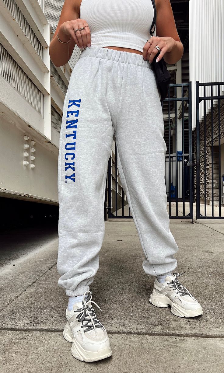 Heather grey jogger sweatpants with UK blue "Kentucky" graphic down the leg in block letters! 80% cotton, 20% polyester Model is 5'6" with a 32DD bust, 27" waist, 36" hips, and wearing a small. Model usually wears size 2/4. This item runs true to size! Block Letters, Grey Joggers, Block Lettering, Jogger Sweatpants, Commonwealth, Kentucky, Heather Grey, Size 2, Sweatpants