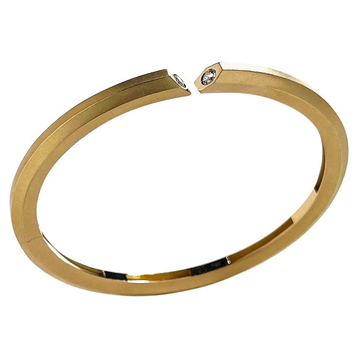 A Geoffrey Good classic, made to be worn forever. Geoffrey has created and restored magnificent jewels for firms and museums including Cartier, Christie's, Sotheby's, Taffin, Verdura, Fred Leighton and The Metropolitan Museum of Art in NYC. 18k yellow gold, hexagonal bar bracelet with spring-loaded, nearly invisible hinge opening on one side. Finished with a single natural diamond on each mitered terminal; .25 carats total. E-F color, VS+ clarity or better. Sized to fit an average female/smaller Modern Diamond Jewelry For Formal Occasions, Luxury Cuff Bracelet With 17 Jewels For Anniversary, Elegant Hallmarked Bangle For Formal Events, Elegant Yellow Gold Cuff Bracelet For Formal Occasions, Elegant Yellow Gold Bangle For Formal Occasions, Hallmarked Yellow Gold Cuff Bracelet For Formal Occasions, Formal Hallmarked Yellow Gold Cuff Bracelet, Modern Yellow Gold Polished Diamond Bracelet, Modern Yellow Gold Diamond Bracelet With Polished Finish