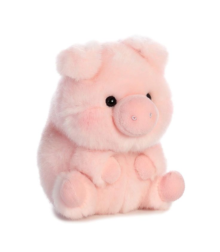 a pink stuffed animal sitting on top of a white surface