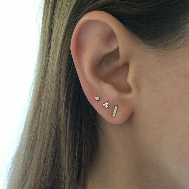 a woman's ear with two small stars on it