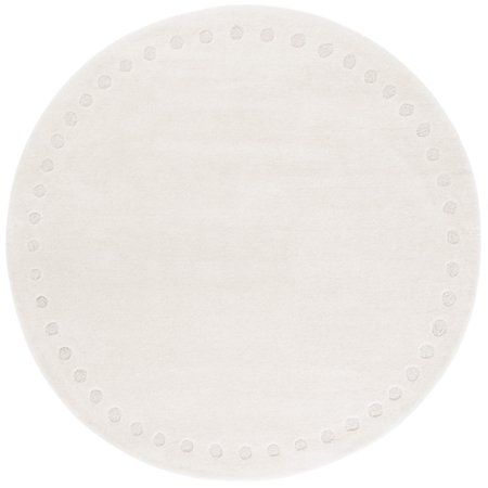 a white round rug with dots on the top and bottom, in front of a white background