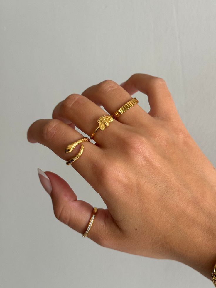 Gold coiled snake ring is adorable and edgy, and a very trendy look for jewelry. Cute serpent snake ring that non-tarnishing - stainless steel and gold - non-tarnishing Socials: Insta: @vasi.jewelry  Site: http://vasijewelry.com Tik Tok: vasi.jewelry Care - protect your jewelry from things that could scratch the surface - keep away from harsh chemicals - store jewelry away from the sun and in a microfiber pouch - clean your pieces with warm water and detergent-free soap and thoroughly dry - poli Gold Minimalist Snake Ring For Promise, Gold Minimalist Snake Ring As Promise Ring, Handmade Gold Snake Ring, Gold Minimalist Snake Ring For Gift, Gold Minimalist Snake Ring, Minimalist Snake Ring As A Gift, Rings Simple Everyday, Chicago Beats, Dainty Ring Stack