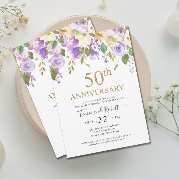 two wedding anniversary cards on a plate next to flowers