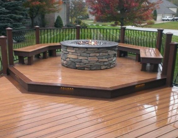 a wooden deck with a fire pit on it