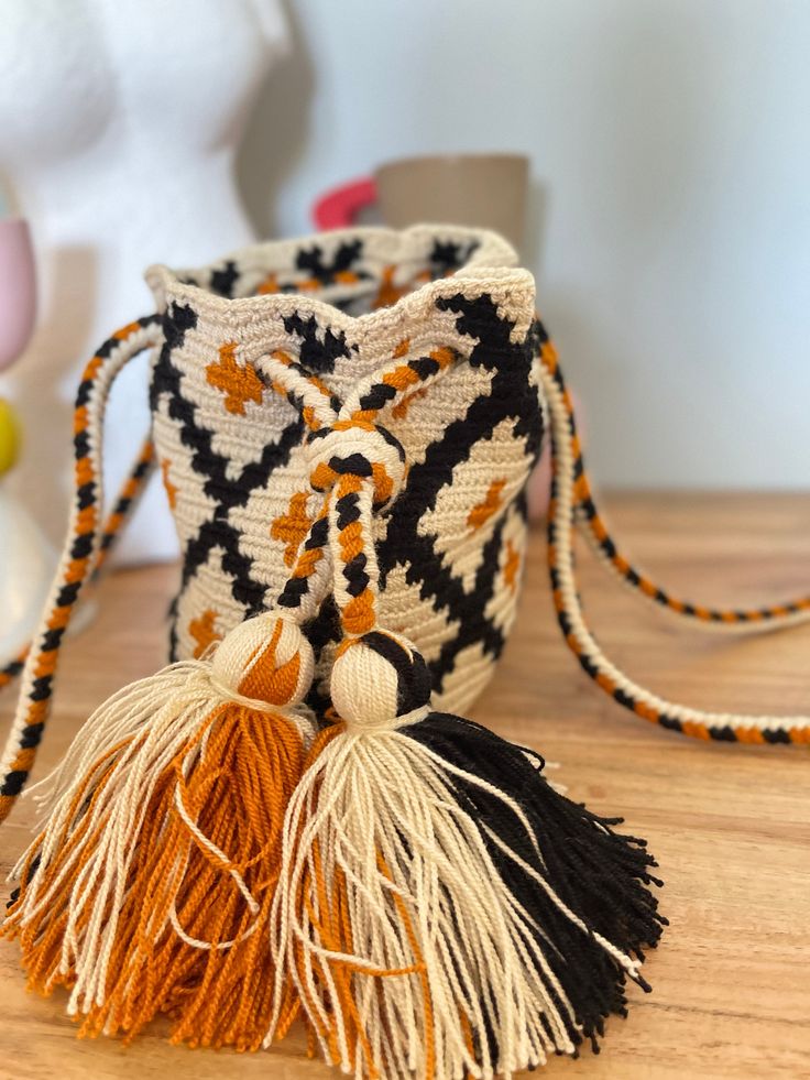 "This one-of-a-kind Wayuu bag is 100% handmade by Wayuu tribe craftswoman in Colombia with ancestral high quality weaving skills. Uniquely designed with no two the same. \"a piece of artwork\" for the people who loves, values and appreciates true craftsmanship. each purchase of a WAYUU PRODUCT PROVIDES CONTINUED SUPPORT TO THE WAYUU COMMUNITY. Elegant, eye-catching shoulder bag will carry all your daily essential things. (etc. phone, water bottle, books, iPad, makeups... )  Fashionable design to complement any outfit and to make a fashion statement. How about a \"diaper bag\" for cute mom and baby. SIZE :  SIZE: H 6 in X  W 8.5 in STRAP: 16 in Care Guide:  Hand wash in cold water Lay flat to dry  Return & Exchange Policies:  We accept return and exchange within 30 days of purchase for any Artisan Handmade Bucket Bag For Daily Use, Bohemian Fair Trade Bucket Bag For Daily Use, Artisan Woven Bucket Bag For Festivals, Bohemian Weaving Bags As Gift, Bohemian Weaving Bags For Gift, Handmade Bohemian Bucket Bag In Natural Color, Bohemian Bucket Bag As A Gift, Artisan Bucket Bag For Festivals, Handmade Bohemian Bucket Bag As Gift