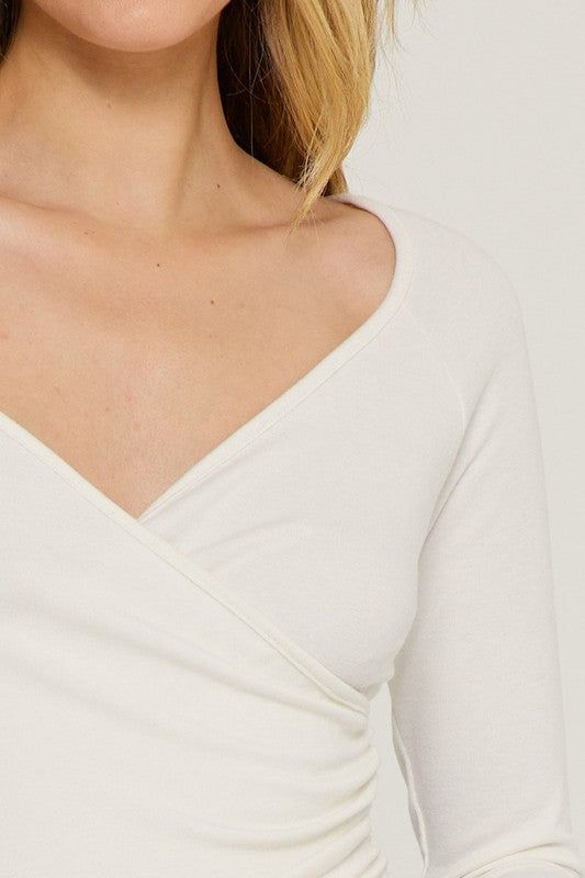 Long Sleeve Deep V-Neck Cross Wrap Top Long sleeves // Deep v-neck // Cross wrap // Knitted top Fitted V-neck Top For Spring Layering, Versatile V-neck Tops For Layering, V-neck Knit Top For Layering, Fitted V-neck Sweater For Spring Layering, V-neck Faux Wrap Top For Layering, Versatile V-neck Tops For Winter, Chic V-neck Knit Top For Layering, Stretch Seamless V-neck Knit Top, Versatile Fitted V-neck Knit Top