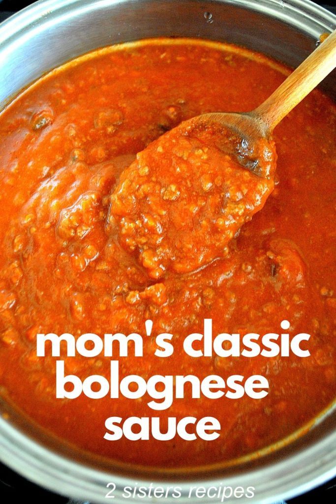 a ladle full of red sauce with the words mom's classic bolognaese sauce