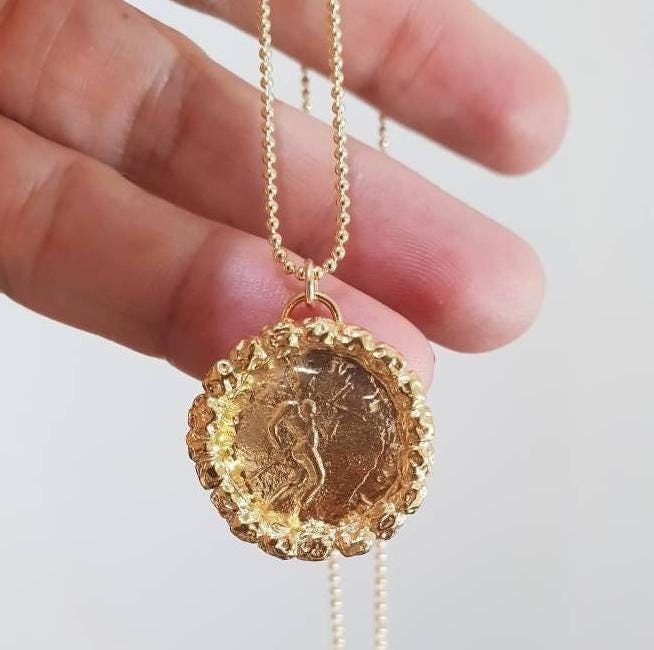 Gold coin necklace, gold  pendant necklace, 14k gold necklace, antique coin necklace, medallion necklace,  long coin necklace Long 14k gold filled necklace with an antique gold coin pendant, decorated with golden hammered beads. Beautiful minimalist round pendant, designed in an antique style, this gold coin medallion necklace is just  a great gift for her. It will be your to go necklace, for day or night, never needing to to take it off. Dimensions: The coin medallion pendant diameter is about Gold Coin-shaped Medallion Necklace With Locket, Gold Necklace Antique, Gold-tone Brass Medallion Coin Necklace, Gold-tone Coin Pendant Necklace In Brass, Gold-tone Brass Coin Necklace, Antique Coin Necklace, Silver Coin-shaped Medallion Necklace In Brass, Coin Necklace Gold, Gold Coin Necklace