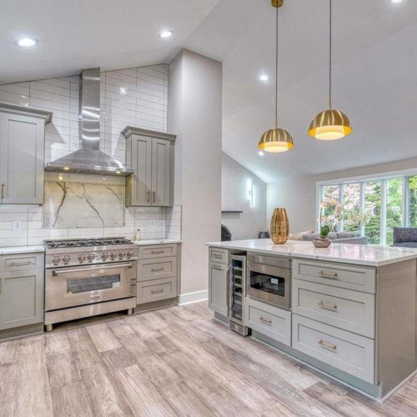 a large kitchen with stainless steel appliances and wood flooring is pictured in this image