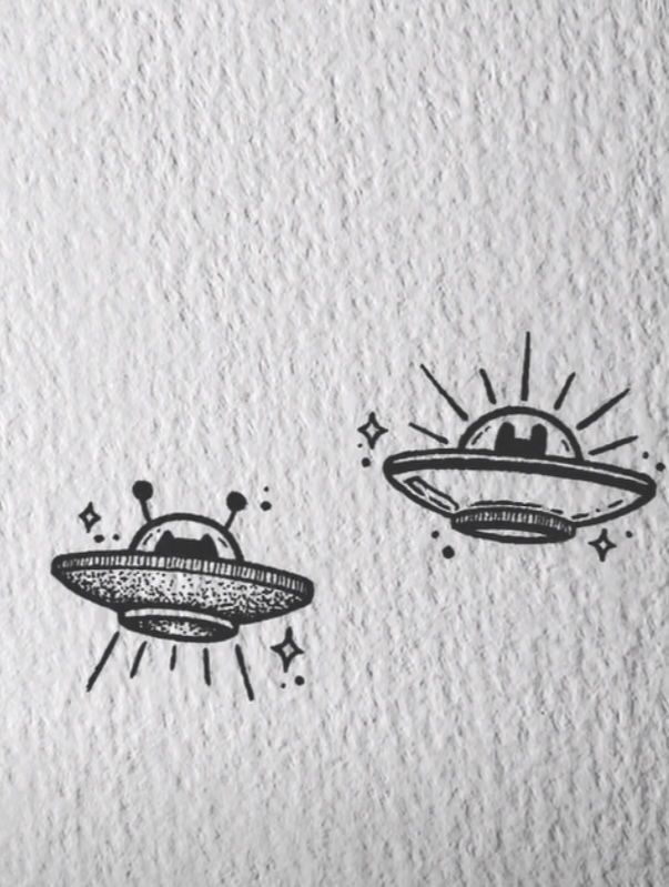 an image of two alien drawings on paper