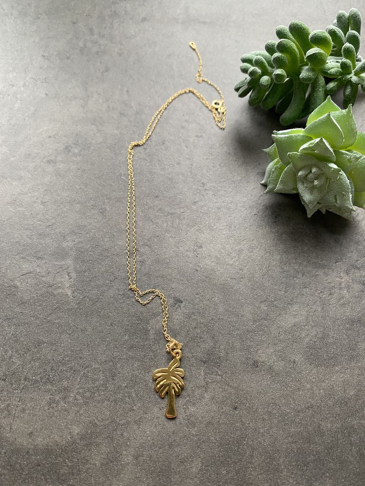 Perfect for vacation, this necklace is made of gold plated 925 silver. Palm tree pendant on a chain (please choose your length from the drop down menu). Handmade in Spain. Dainty Beach Necklace With Delicate Chain, Dainty Necklace With Delicate Chain For Beach, Gold Minimalist Necklace For Beach, Dainty Beach Jewelry With Delicate Chain, Minimalist Gold Necklace For Beach, Minimalist Gold Necklaces For The Beach, Dainty Necklaces For Vacation, Beach Pendant Jewelry With Clavicle Chain, Elegant Beach Pendant Charm Necklaces