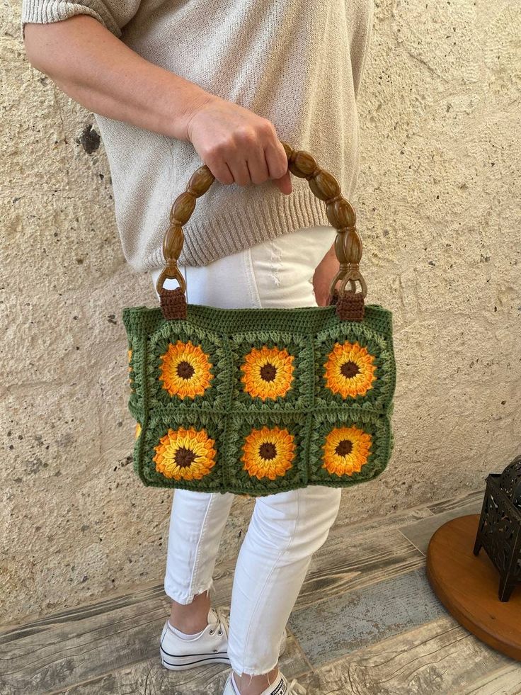 Granny Square Boho Bag, This colorful and stylish crochet boho bag is the perfect accessory for any fashion-forward individual who loves unique and handmade items. It's versatile and functional, serving as summer clutch and handbag to accommodate all your belongings. Measurements: ♥Width: 28 cm ♥Height without handles: 20 cm ♥Total height with handles:39 cm  It has acrylic handle Green Square Crochet Bag, Green Hand-knitted Crochet Tote Bag, Green Crochet Bag With Granny Square For Daily Use, Green Handheld Crochet Bag With Handles, Green Crochet Granny Square Bag For Everyday Use, Green Granny Square Crochet Bag For Everyday Use, Green Rectangular Crochet Bag With Handles, Summer Green Crochet Bag With Granny Square, Green Crochet Tote Bag