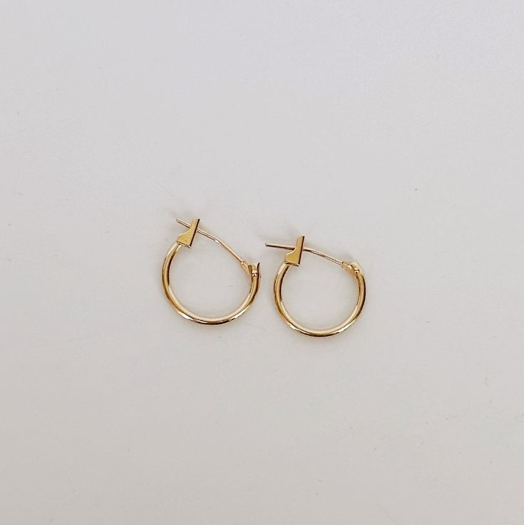 Add a touch of elegance to your everyday look with our 10k yellow solid gold huggie earrings. These timeless earrings are crafted to hug your earlobe comfortably and securely, making them perfect for everyday wear. And, with their simple yet stylish design, they're the ideal foundation for adding your favorite charms to create a personalized look that's uniquely yours. Try adding our Medusa Pendant for an edgy drop earring style. Details Crafted in solid 10k yellow gold for strength, comfort, an