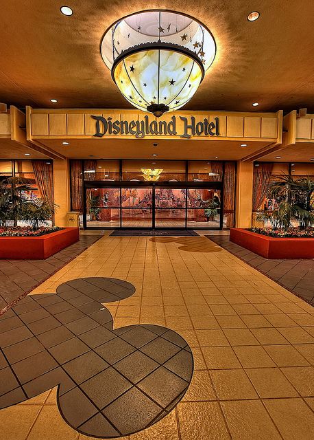 the entrance to disneyland's hotel is decorated in gold and black with an image of mickey mouse on it