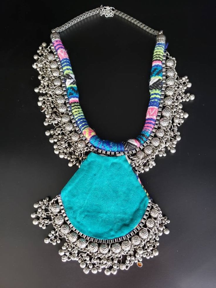 "Dramatic hand crafted silver tone boho statement necklace with fascinating sun pendant. Toss it on a black or pink tank top to renew a tired outfit. Beautiful, multilayered, eye catching piece. Wear this and you WILL be noticed! Visually striking and dramatic! Fabric backing for comfort. Fine quality and craftsmanship. Fabric will vary slightly from piece to piece, but the color palette is the same! Like they say \"Go big or go home\". Live to the fullest! Love the necklace but want it in a gol Handmade Metal Necklace For Festivals, Bohemian Metal Necklaces For Festivals, Hippie Festival Pendant Necklace, Bohemian Handmade Pendant Bib Necklace, Handmade Bohemian Pendant Bib Necklace, Multicolor Oxidized Bohemian Necklaces, Silver Bohemian Necklace For Festivals, Bohemian Necklace With Large Pendant, Bohemian Necklaces For Festivals