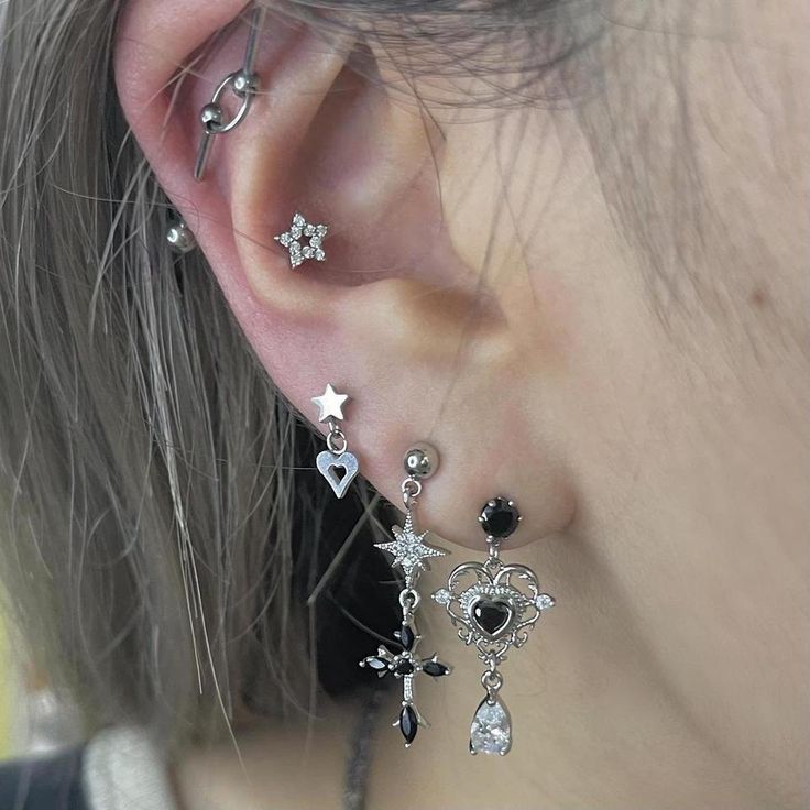 a close up of a person with ear piercings on their ears and wearing jewelry