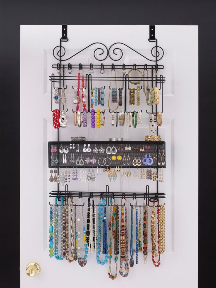 a wall mounted jewelry rack with many different necklaces