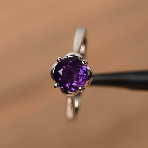 It is a natural amethyst ring, round cut, measures 7mm*7mm, weight about 1.25 cts. The basic metal is sterling silver and plated with rhodium.To change the metal to a solid gold (white/rose) or platinum is also available, please ask for a quotation if you want.You can also go to my shop Home for more elegant rings: https://www.etsy.com/shop/godjewelry?ref=hdr_shop_menuamethyst is the birthstone of February. More amethyst rings:https://www.etsy.com/shop/godjewelry?ref=seller-platform-mcnav&se Elegant Round Amethyst Birthstone Ring, Elegant Amethyst Birthstone Ring, Round Amethyst Birthstone Ring In Fine Jewelry Style, Purple Birthstone Ring With Prong Setting, Silver Amethyst Round Promise Ring, Silver Amethyst Ring With Birthstone In Round Cut, Amethyst Solitaire Birthstone Ring, Round Cut, Silver Amethyst Ring With Round Cut Birthstone, Amethyst Birthstone Ring Solitaire Round Cut