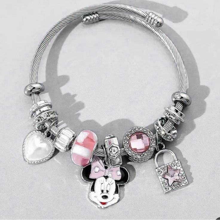 Lovely Disney Bracelet Features Everyone's Favorite Mouse, Minnie! Made Of Shiny Silver And Adorned With Charming Charms, This Bracelet Is A Must-Have For Any Disney Fan. Perfect For Adding A Touch Of Magic To Any Outfit, This Bracelet Is Great For Everyday Wear Or For Special Occasions. The Charms Include Minnie's Iconic Bow, A Heart, And A Key, Making This Bracelet Both Whimsical And Elegant. Ideal For Gifting Or For Treating Yourself, This Disney Minnie Mouse Bracelet Is Sure To Bring A Smile Cute Silver Stainless Steel Jewelry, Disney Silver Bracelet Gift, Disney Silver Bracelet For A Gift, Silver Disney Charm Bracelet Gift, Silver Disney Bracelet For Gift, Silver Disney Charm Bracelet As A Gift, Silver Disney Bracelet As Gift, Disney Silver Charms Jewelry, Disney Silver Jewelry With Charms