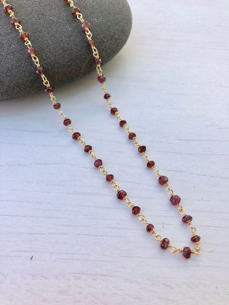 Garnet Necklace, Garnet Beaded Necklace, January Birthstone, Dainty Garnet Necklace, Red Choker Necklace, Simple Gold Necklace, Gift for her Beaded red garnet rosary style necklace wire wrapped in 14k gold filled or sterling silver. Rondelles are 3mm in size. Necklace closes with lobster clasp in the finish of your choice. About This Necklace: - Stone: Garnet - Birthstone Month: January - Garnet Properties: Friendship, Love and Guidance - Stone Size: 3mm - Necklace Length: Choice of 16 or 18 inc Red Beaded Ruby Necklace, Red Ruby Beaded Necklaces For Jewelry Making, Red Beaded Chain Necklace Gift, Red Beaded Chain Necklace For Gift, Gift Red Beaded Chain Necklace, Red Ruby Gemstone Bead Necklaces, Red Ruby Gemstone Beads Necklaces, Red Ruby Gemstone Beads Necklace, Red Garnet Round Beads Jewelry