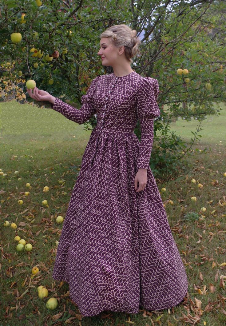 This charming dress has a jewel neckline, front button closure and leg-o-mutton long sleeves. The fitted bodice has a full skirt gathered at the waist. This dress also features our three-paneled full skirt with pockets. Hand wash or machine wash and dry gently. 100% sturdy cotton. The model is wearing boots and a crinoline, which are priced separately. Designed and made proudly by Recollections in America! The following are approximate finished measurements and include room for ease of movement. Prairie Dresses Carolyn Ingals, Fall Dresses With Gathered Skirt, Fall Dresses With Gathered Full Skirt, Fall Dresses With Full Gathered Skirt, Fitted Long Sleeve Dress With Modesty Panel, Long Sleeve Gathered Skirt Fall Dress, Long Sleeve Dress With Gathered Skirt For Fall, Classic Fitted Long Sleeve Prairie Dress, Long Sleeve Dresses With Buttons For Garden Party