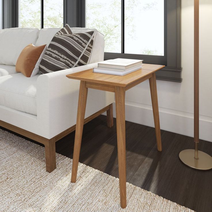 a white couch sitting next to a wooden table