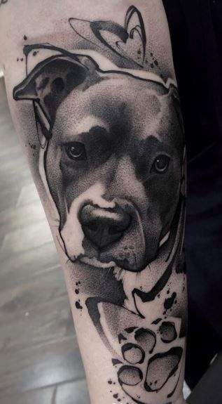 a black and white dog tattoo on the arm