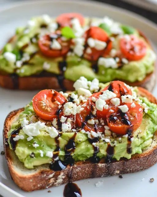 two pieces of bread with avocado and tomatoes on them