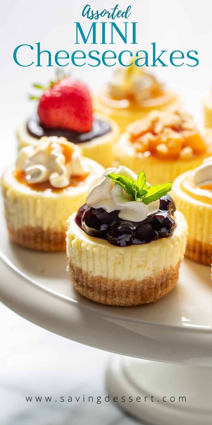 mini cheesecakes on a white plate with blueberries and strawberries in the background