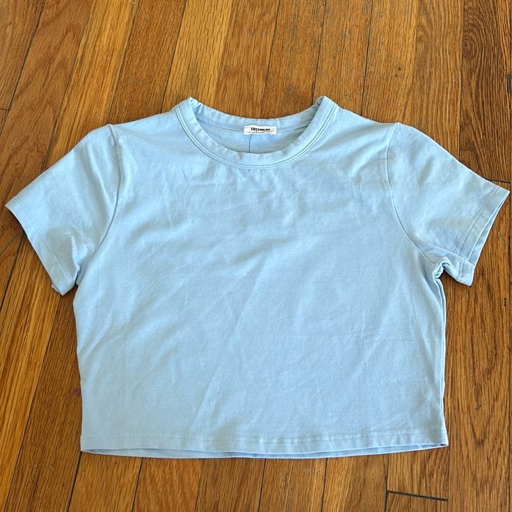 Never Worn! In Perfect Condition. Blue Trendy Relaxed Fit Crop Top, Trendy Blue Cotton Top, Blue Relaxed Fit Crop Top, Blue Relaxed Fit Trendy Crop Top, Blue Stretch Crop Top T-shirt, Plain Cotton Crop Top For Summer, Plain Cotton Crop Top For Spring, Everyday Light Wash Cotton Tops, Trendy Light Blue Crew Neck Crop Top