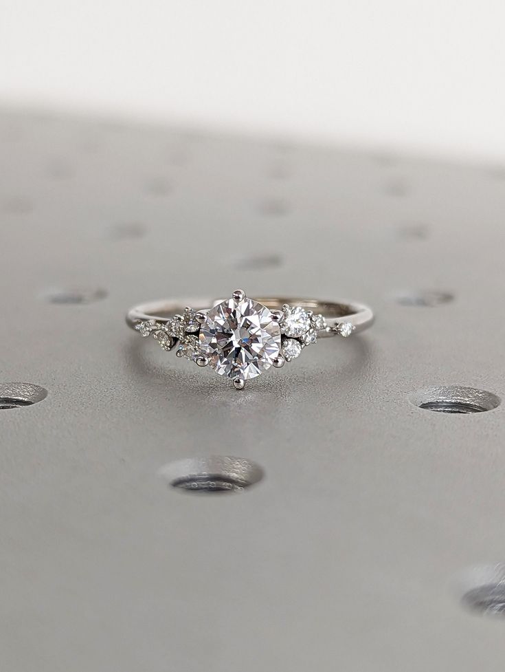 three stone engagement ring with diamond accents