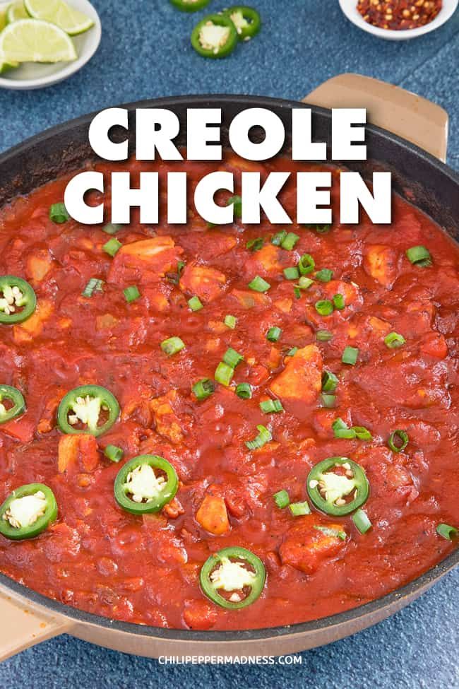 a skillet filled with chicken and vegetables on top of a blue counter next to limes